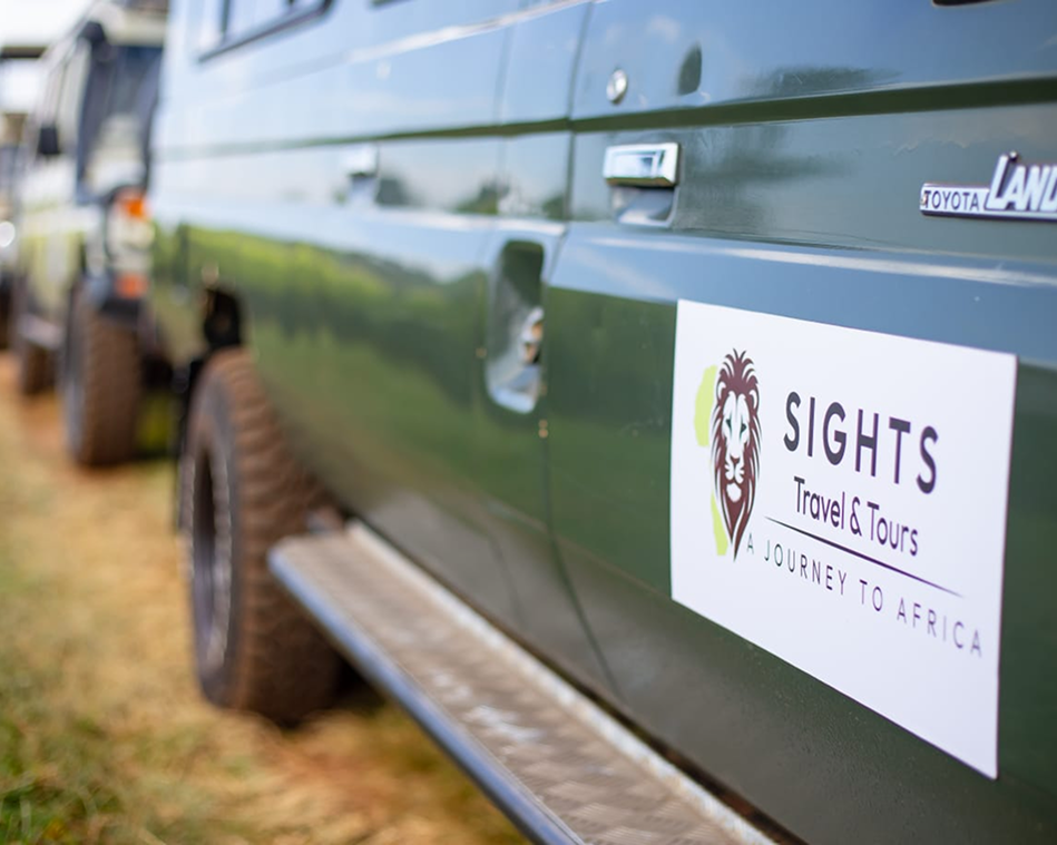 Green off-road vehicle with a "SIGHTS" tour company logo on the door.